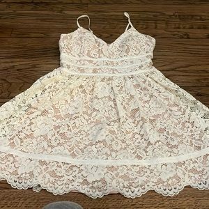 Beautiful white lace dress with nude lining. Wore it one time and had cups sewn